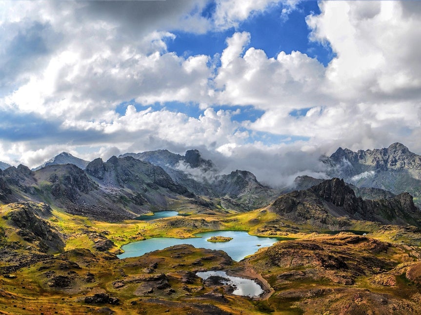 landscape photo of mountains in background and lake in foreground