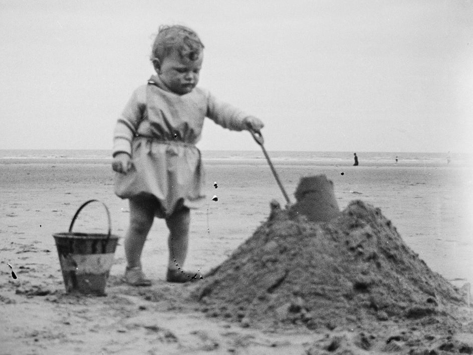 black and white photo of child at beach