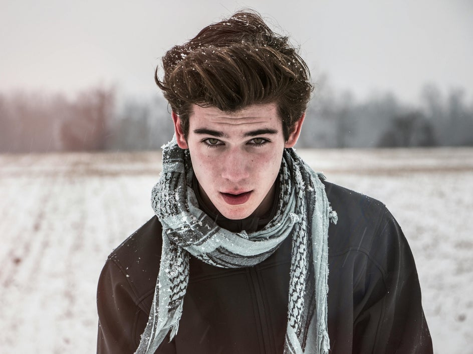 portrait of boy standing in snow