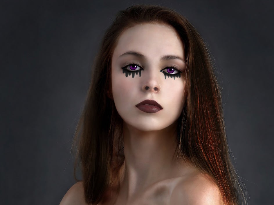 female portrait with grey background with scary makeup look applied