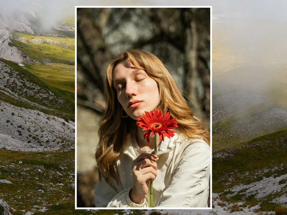 female portrait with flower and hillside bakground