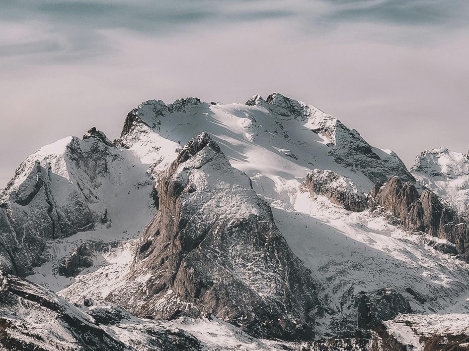 snowy mountain tops with grey and pink undertones