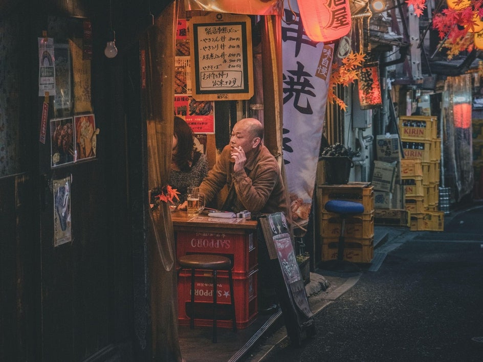 Japanese street pub with man smoking at table