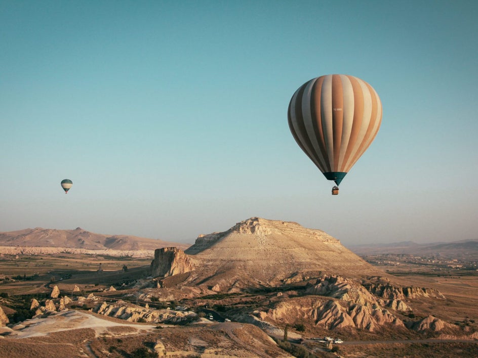 hot air balloon with blue skyline and hills