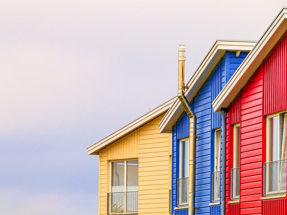 yellow, blue, and red houses on a grey cloudy background