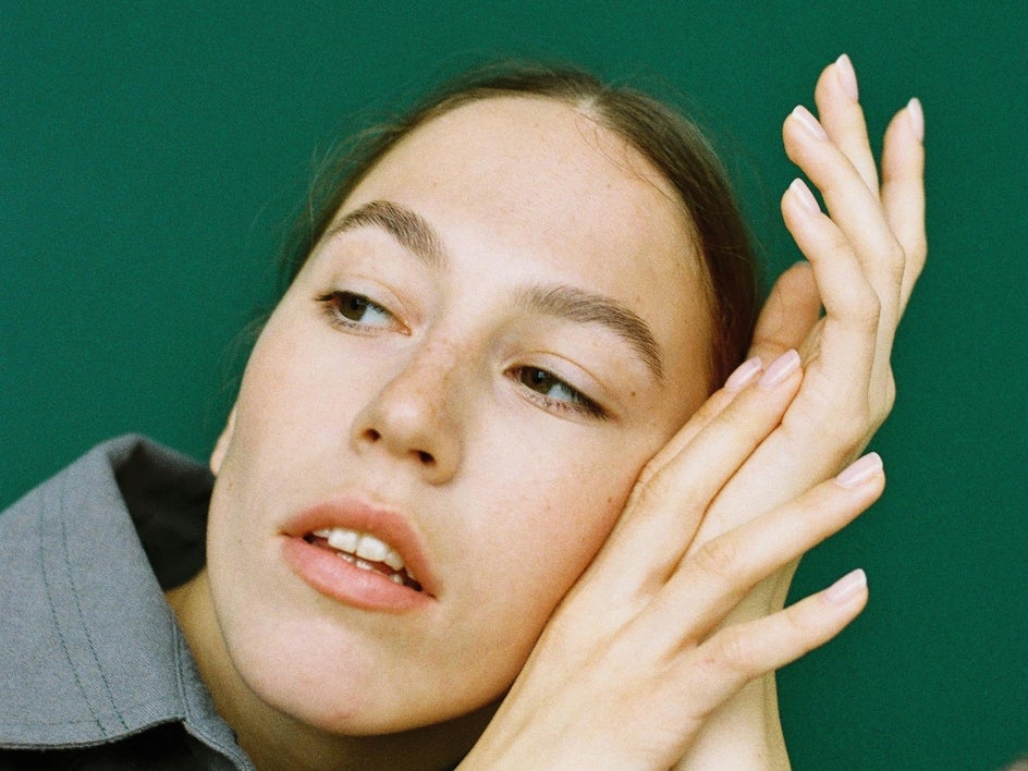 Before: up close female portrait with green background