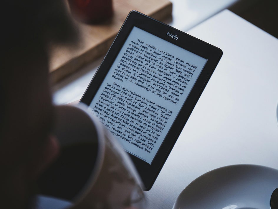 kindle held by woman on table