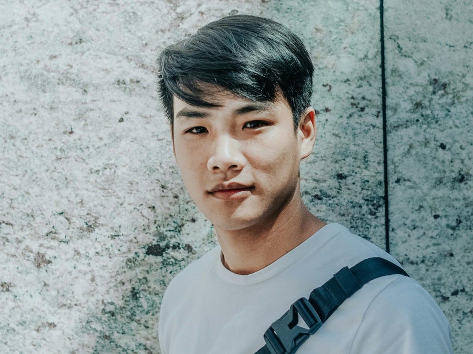 before: asian man posing in simple clothing against marble wall